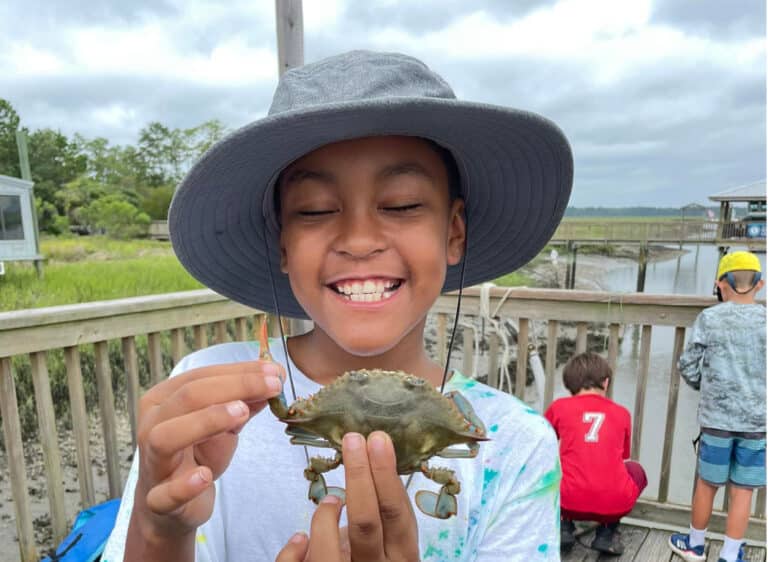 prsf donate girl smiling wiht crab